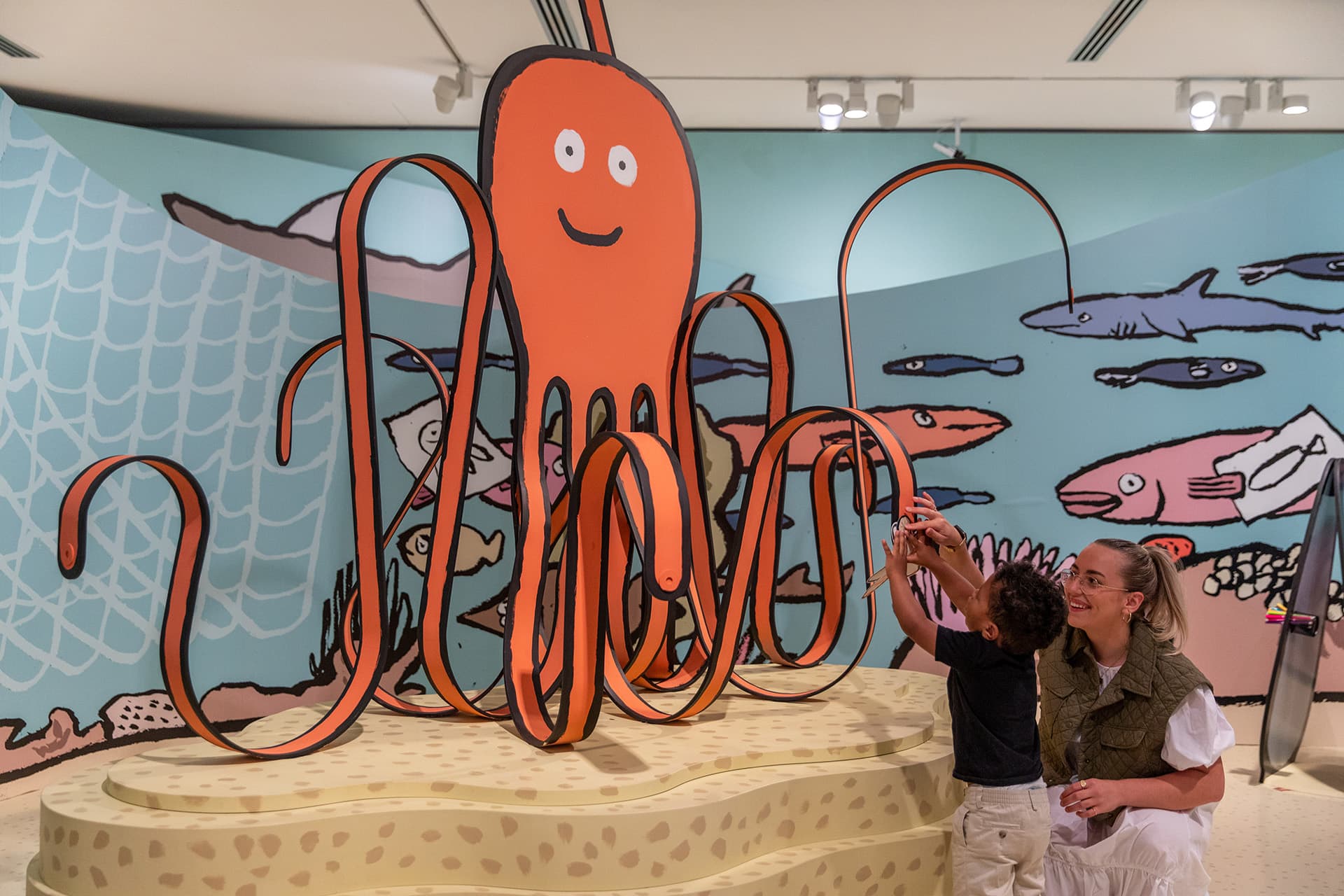 Visitors enjoying <em>RIFIFI: Jean Jullien for Kids</em> on display as part of NGV Triennial  at NGV International, Melbourne. Photo: Kate Shanasy